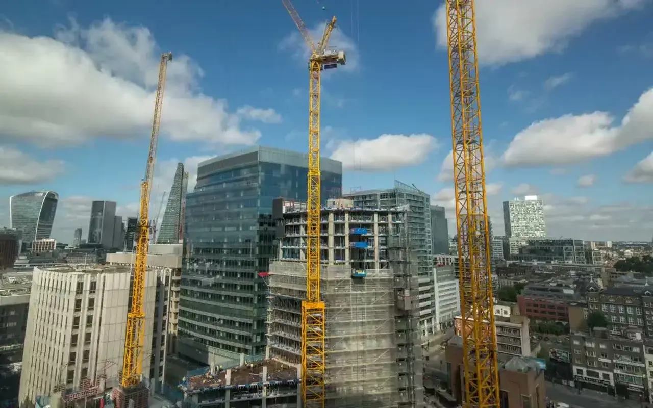 Capital Exterior site hero: tower cranes over a commercial build.